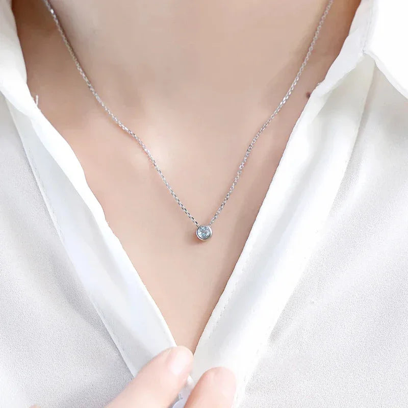 Round Aquamarine Bezel Pendant Necklace worn at the neckline in a close-up