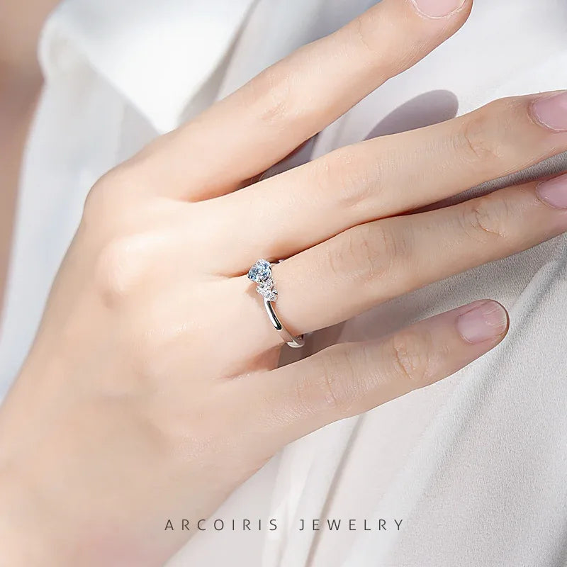 Round Aquamarine Floral Accent Ring worn on the hand in a close-up