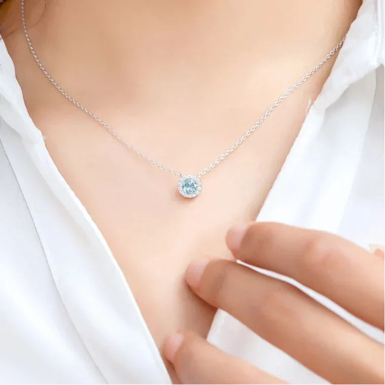 Round Aquamarine Halo Pendant Necklace worn at the neckline in a close-up