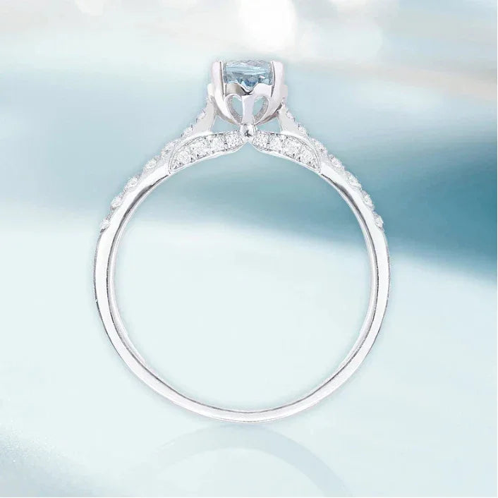Round Aquamarine Pave Ring worn on the hand in a close-up