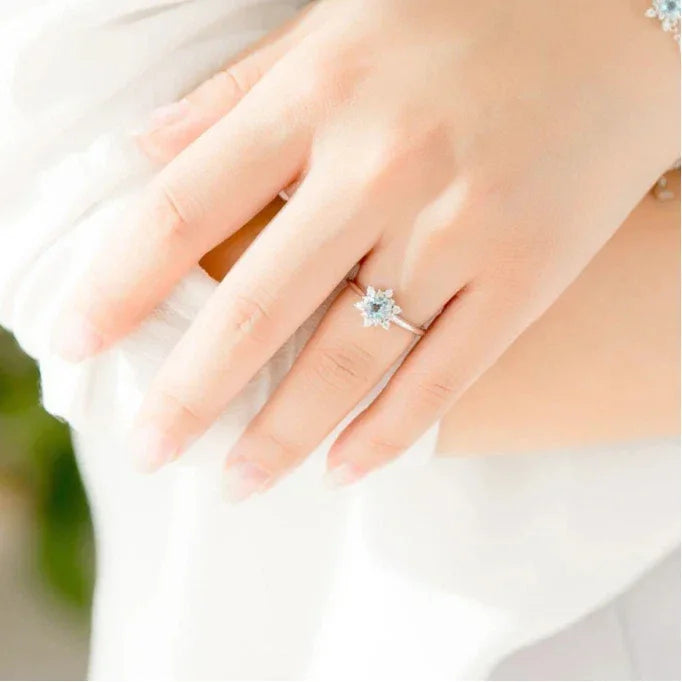 Round Aquamarine Snowflake Halo Ring styled hand view showing ring scale