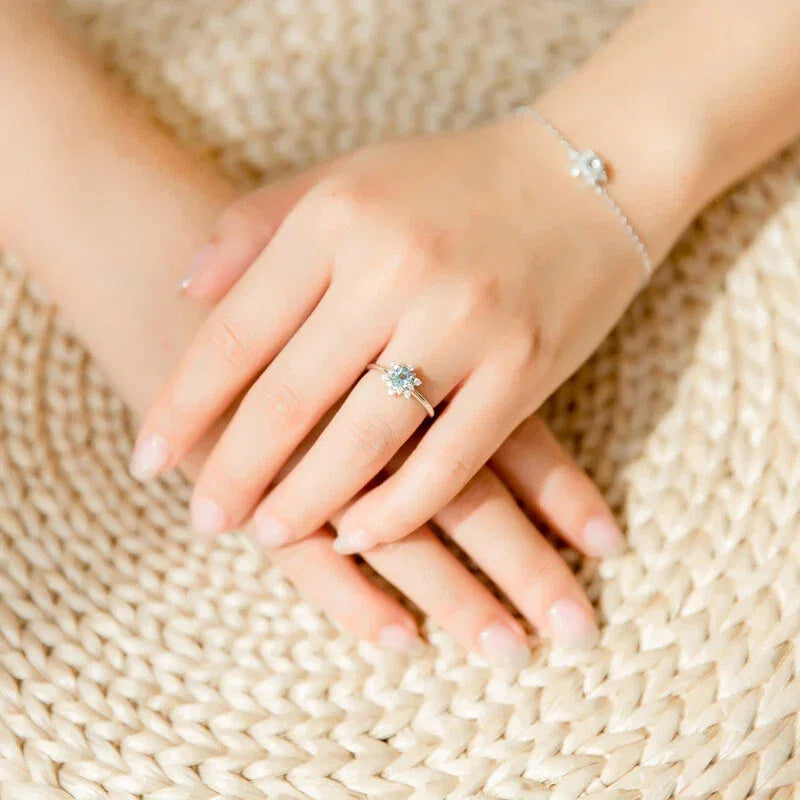 Round Aquamarine Snowflake Halo Ring worn on the hand from a second angle