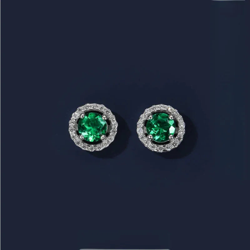 Round Emerald Halo Stud Earrings paired product view on a dark background