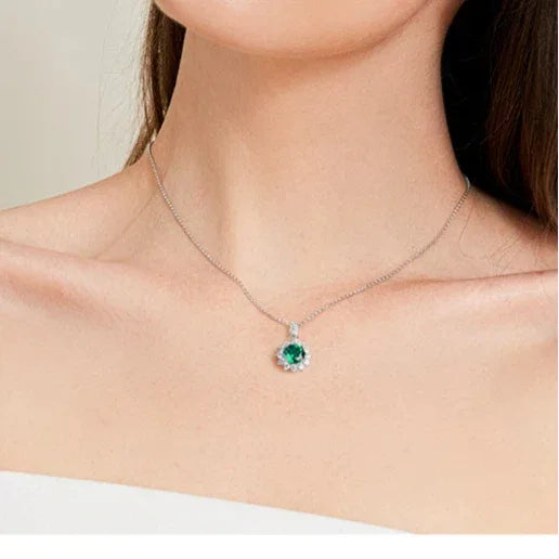 Round Emerald Sunflower Pendant Necklace worn at the neckline in a close-up