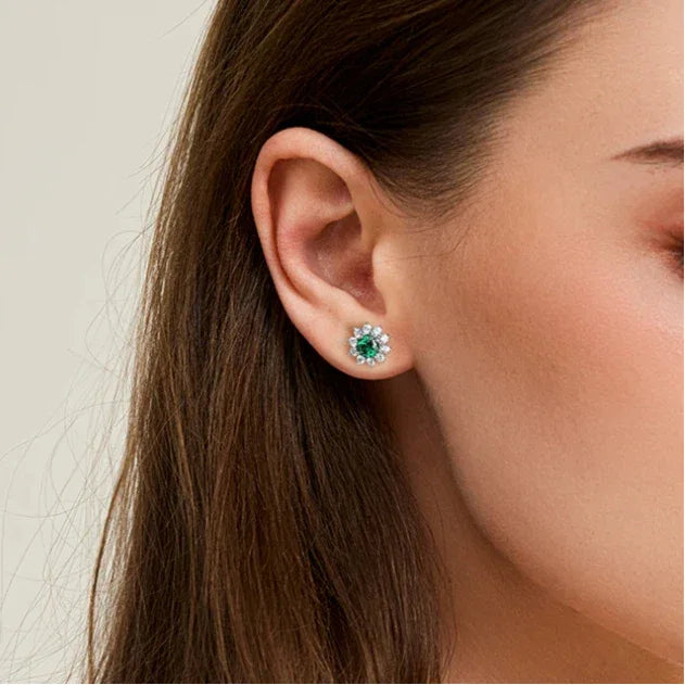 Round Emerald Sunflower Stud Earrings worn on the ear in a close-up