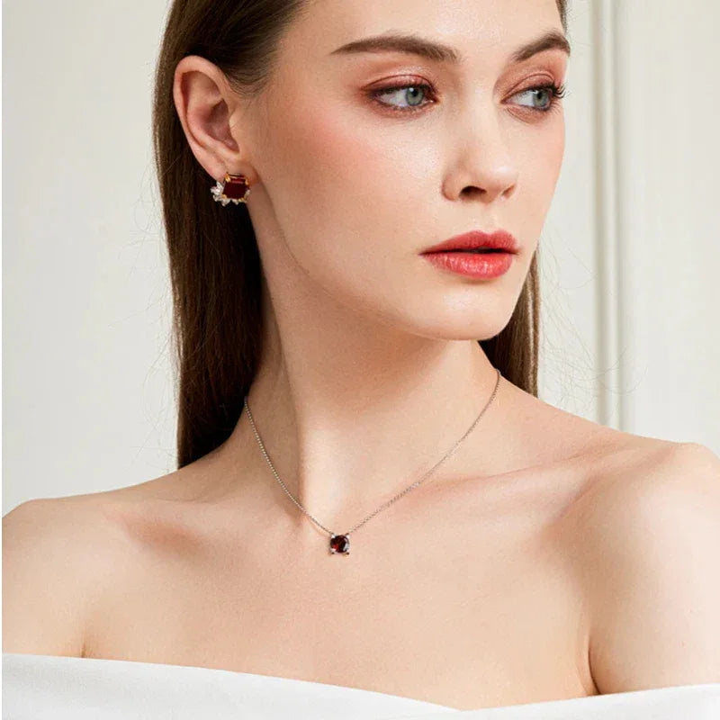 Round Garnet Bar-Set Pendant Necklace pendant styled on a jewelry display