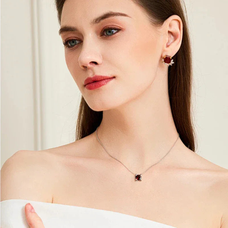 Round Garnet Bar-Set Pendant Necklace worn at the neckline in a close-up