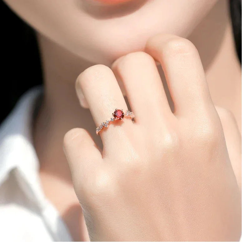 Round Garnet Crown Band Ring side view held between the fingers
