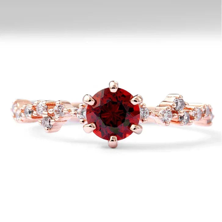 Round Garnet Crown Band Ring worn on the hand in a close-up