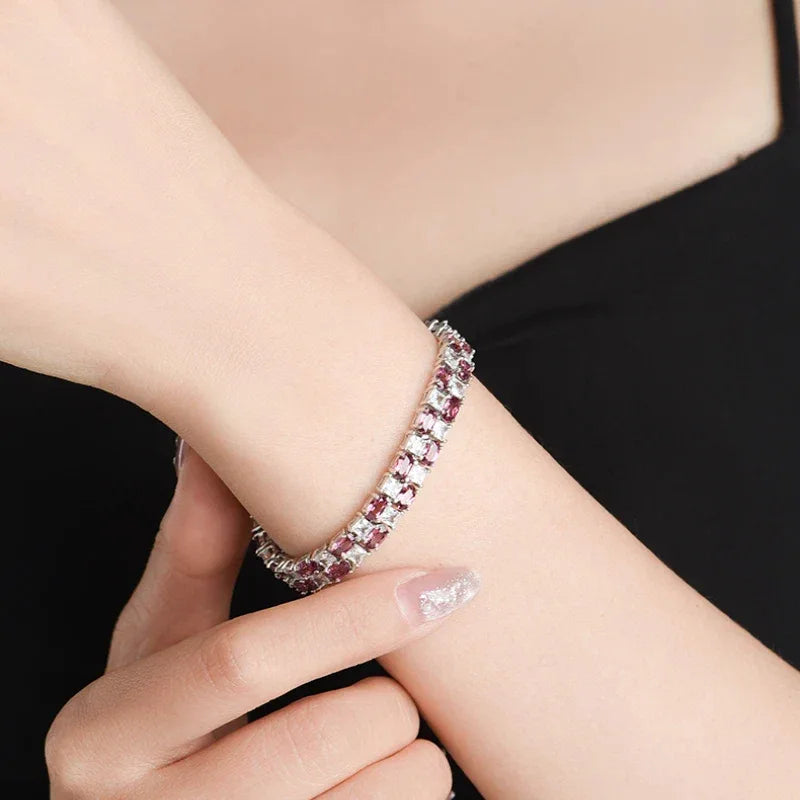 Round Garnet Tennis Bracelet full bracelet view on a dark background
