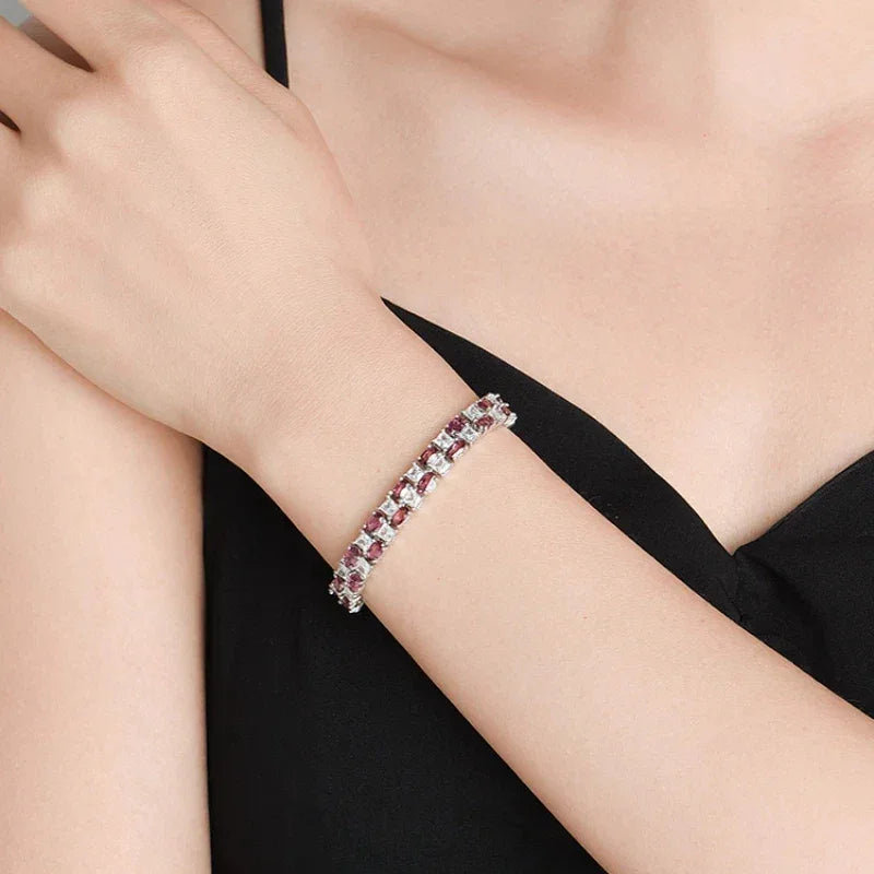 Round Garnet Tennis Bracelet worn on the wrist in a close-up