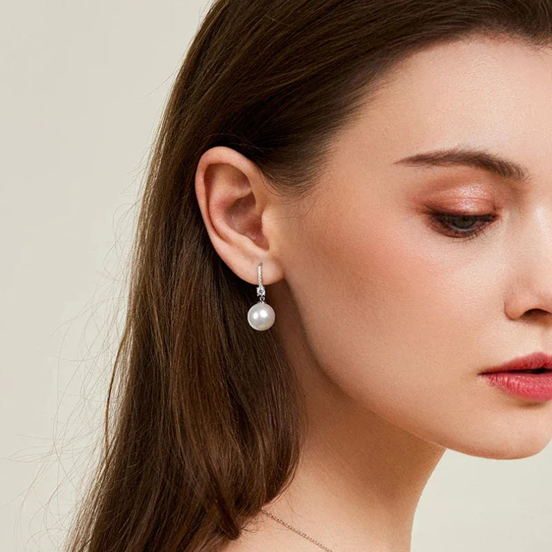 Pearl Drop Earrings with Floral Connector — alternate left-ear worn view