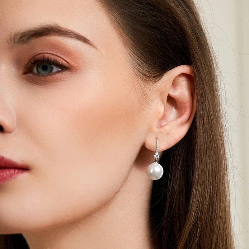 Pearl Drop Earrings with Floral Connector — right-ear worn portrait showing the earring profile