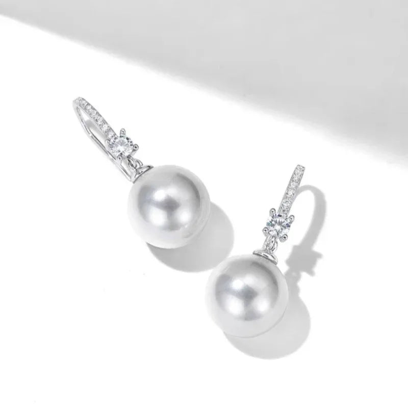 Pearl Drop Earrings with Floral Connector — angled pair showing the lever-back fittings