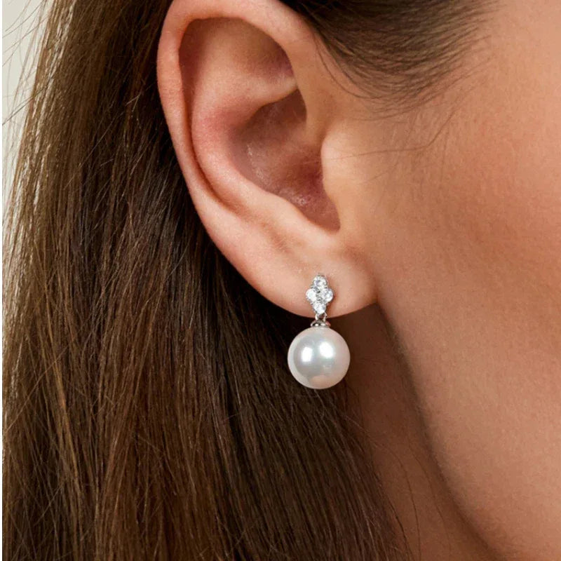 Pearl Teardrop Stud Earrings — close right-ear worn view showing the pearl drop below the stud