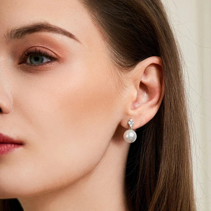 Pearl Teardrop Stud Earrings — right-ear worn portrait showing both earrings