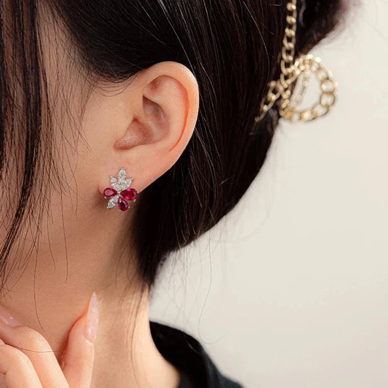 Ruby and Sapphire Floral Stud Earrings — earrings worn on ear