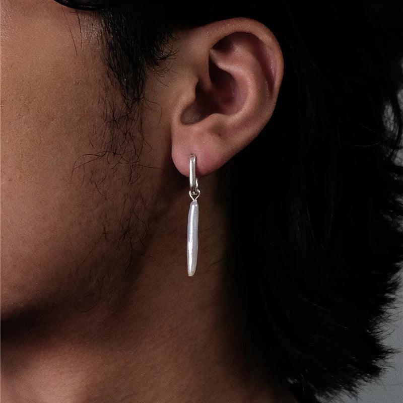 Long Baroque Pearl Drop Earrings — left-ear worn close-up showing the long vertical pearl scale