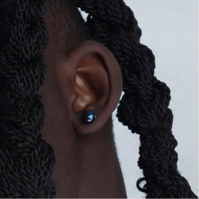Dark Pearl Stud Earrings — right-ear worn close-up showing scale