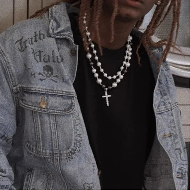 Black and White Pearl Double-Strand Cross Necklace — front model portrait wearing the necklace over a black shirt