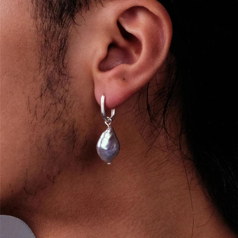 Irregular Pearl Drop Huggie Earrings — alternate left-ear worn side view