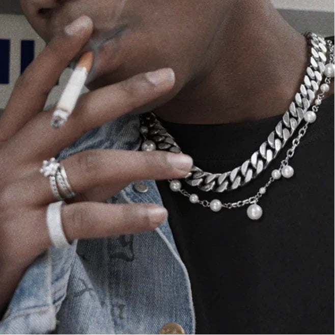Adjustable Pearl Station Chain Necklace — close model view beside a hand showing the scattered pearls