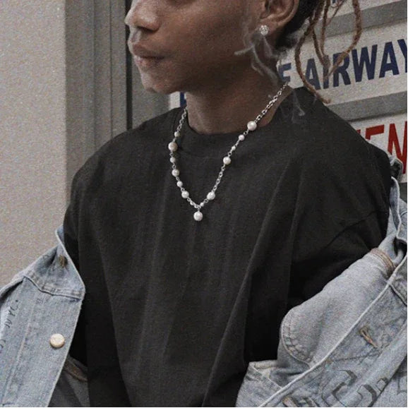 Adjustable Pearl Station Chain Necklace — waist-up model portrait wearing the necklace under a denim jacket