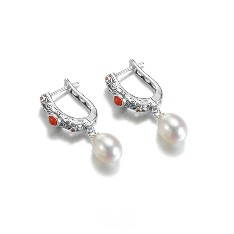 S925 Silver Pearl Drop Huggie Earrings with Red Accent — angled pair showing the hoop clasps and reverse settings