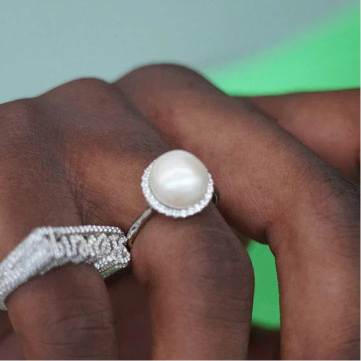 Adjustable Pearl Halo Ring — ring worn on a hand beside other silver-tone rings