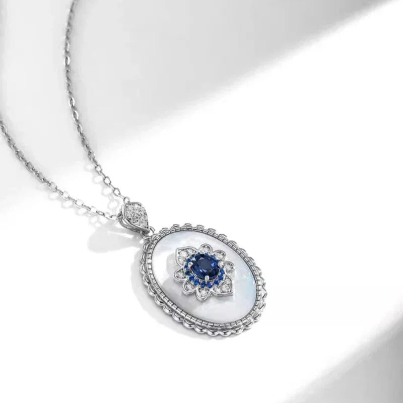 Sapphire and Mother-of-Pearl Oval Pendant Necklace — angled pendant close-up on white