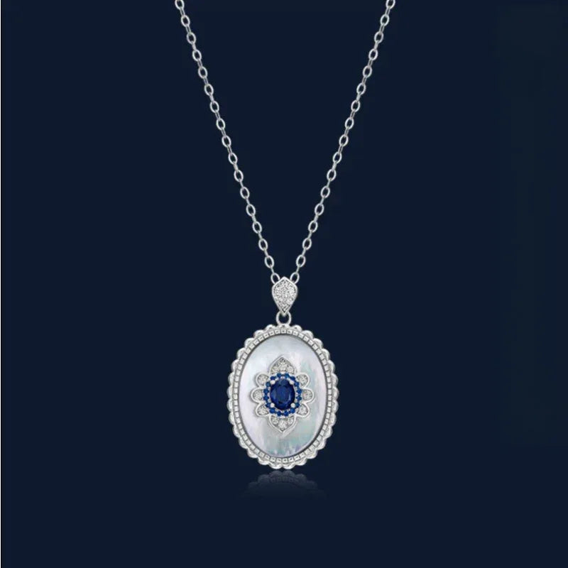 Sapphire and Mother-of-Pearl Oval Pendant Necklace — full necklace displayed on a dark background