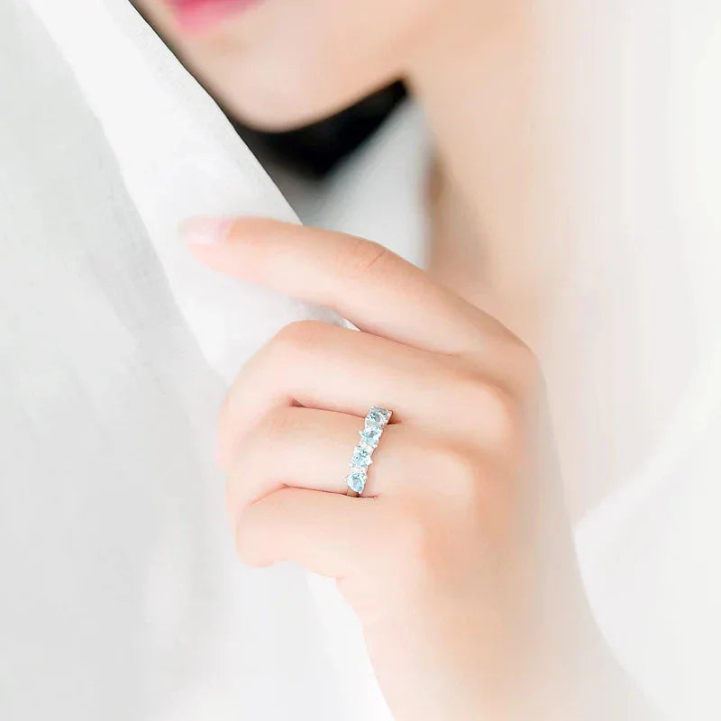 Seven-Stone Aquamarine Band Ring styled hand view showing ring scale