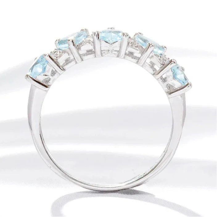 Seven-Stone Aquamarine Band Ring worn on the hand in a close-up