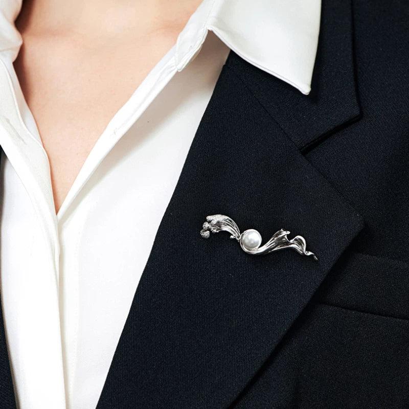 Pearl Flowing Ribbon Brooch — close blazer-worn view showing scale