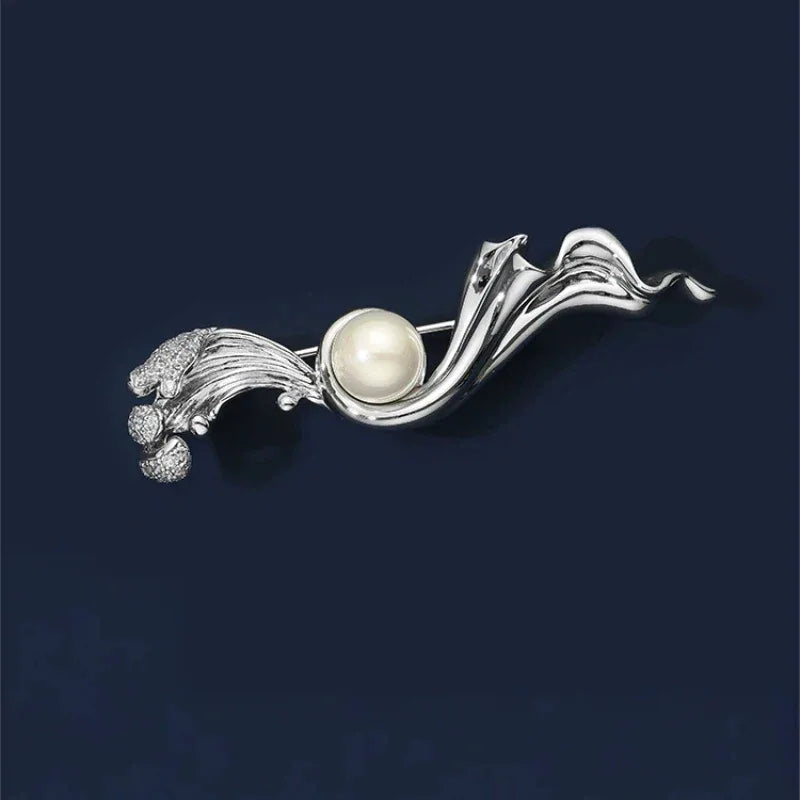 Pearl Flowing Ribbon Brooch — front product view on a dark background