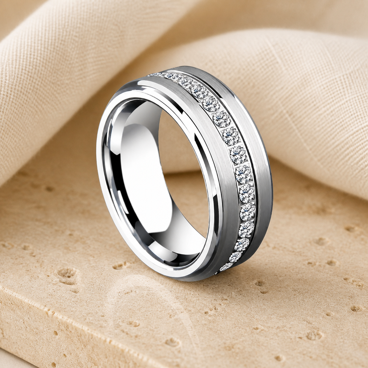 Silver-tone wide spinner ring with a channel of clear zirconia stones on warm beige stone