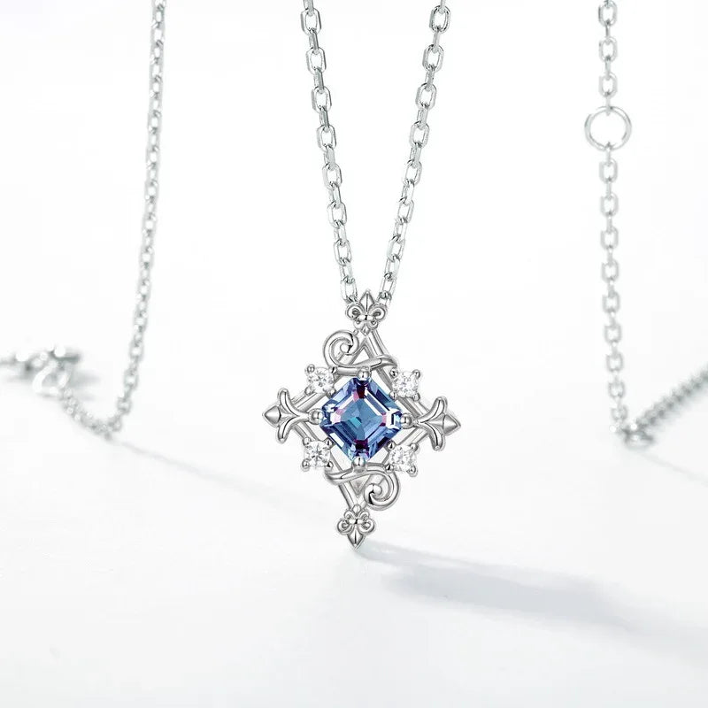 Square-cut Alexandrite filigree pendant necklace, center stone close-up on a white background