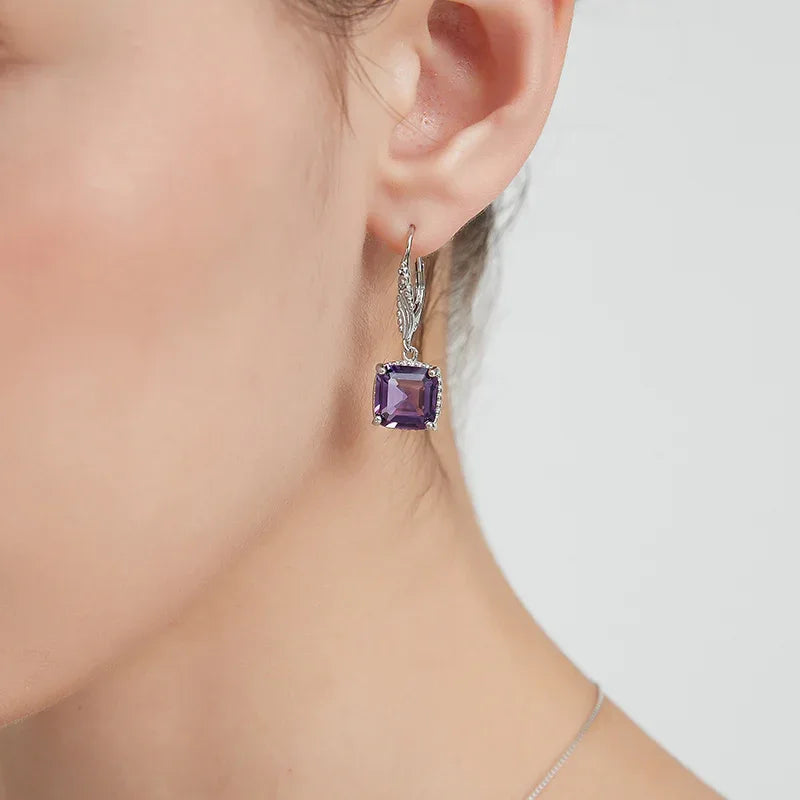 square-cut amethyst drop earrings worn on the ear from a second angle