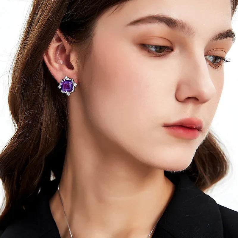 square-cut amethyst stud earrings worn on the ear in a close-up