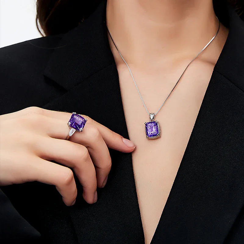 square-cut amethyst ring worn on the hand in a close-up
