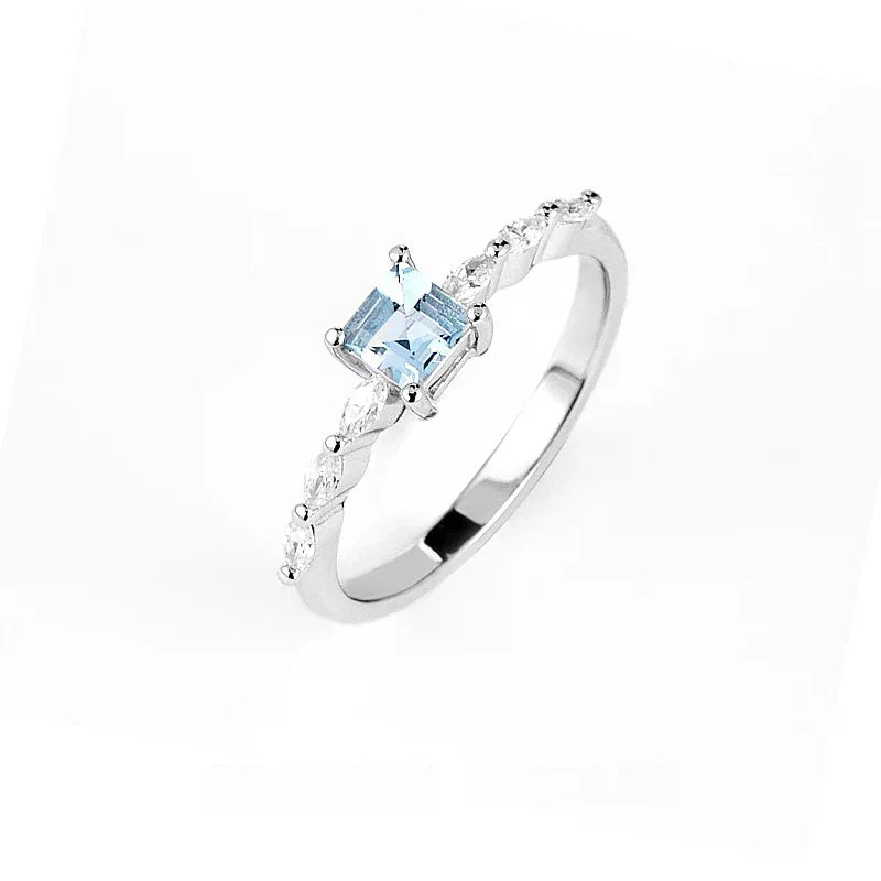 Square-Cut Aquamarine Accent Ring worn on the hand in a close-up