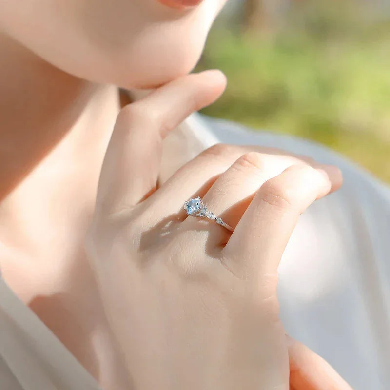 Square-Cut Aquamarine Crown Ring worn on the hand in a close-up