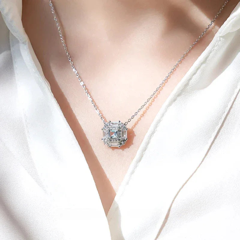 Square-Cut Aquamarine Geometric Halo Necklace worn at the neckline in a close-up