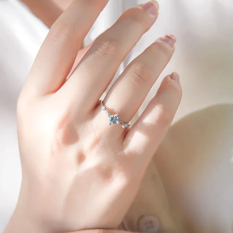 Square-Cut Aquamarine Open Ring worn on the hand in a close-up