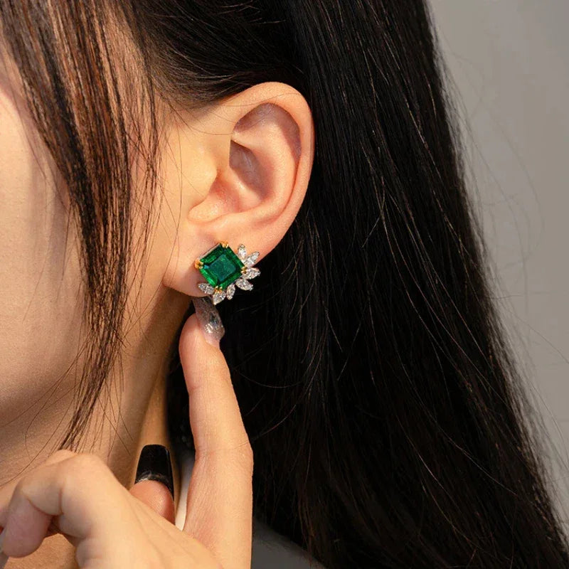 Square-Cut Emerald Floral Stud Earrings styled ear view showing scale