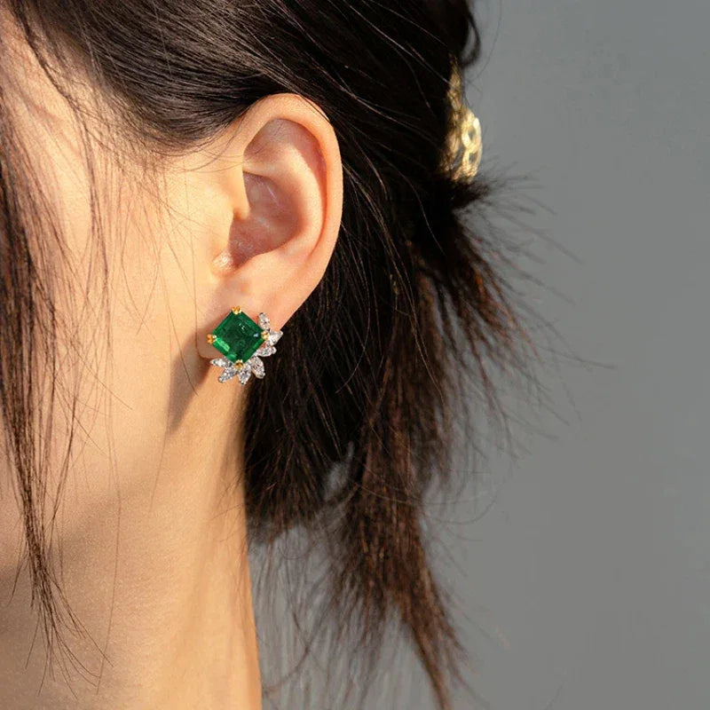 Square-Cut Emerald Floral Stud Earrings worn on the ear from a second angle