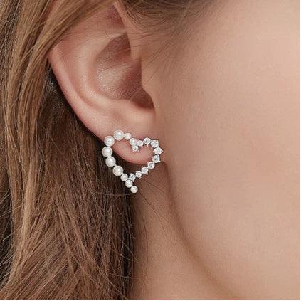 Pearl and Textured Open Heart Stud Earrings — left-ear worn close-up showing the open heart scale
