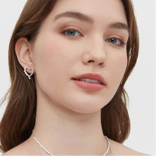 Pearl and Textured Open Heart Stud Earrings — front model portrait wearing the earrings