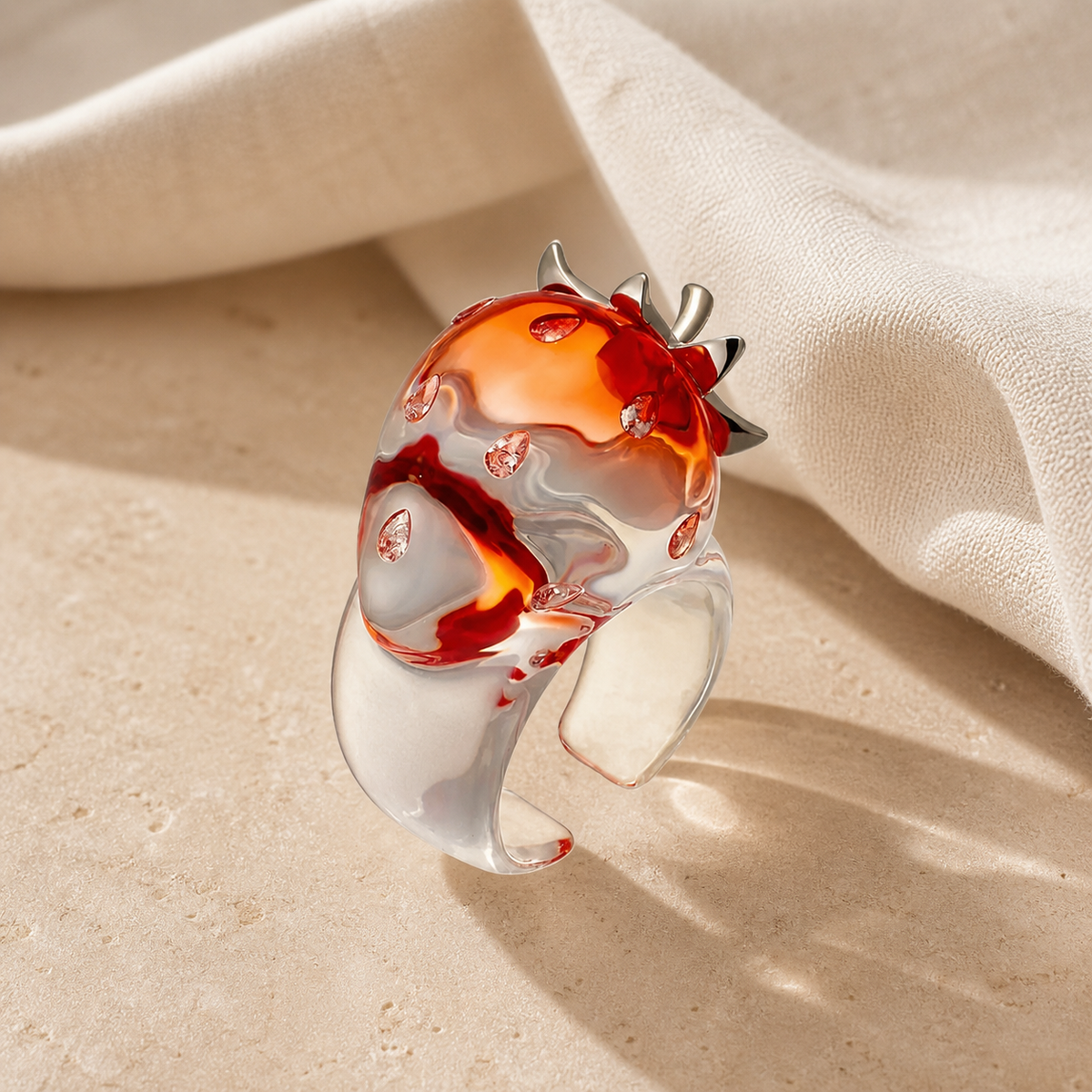 Transparent open ring with an orange-red gradient strawberry top and silver leaf details
