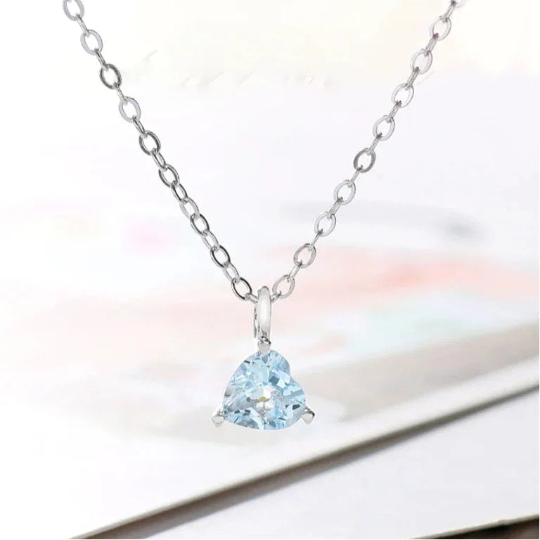 Triangle-Cut Aquamarine Pendant Necklace pendant and chain detail on a light background